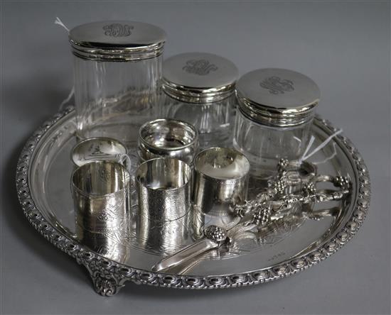 Five silver napkin rings, various, three silver-mounted toilet bottles, a plated tray and pair of grape scissors